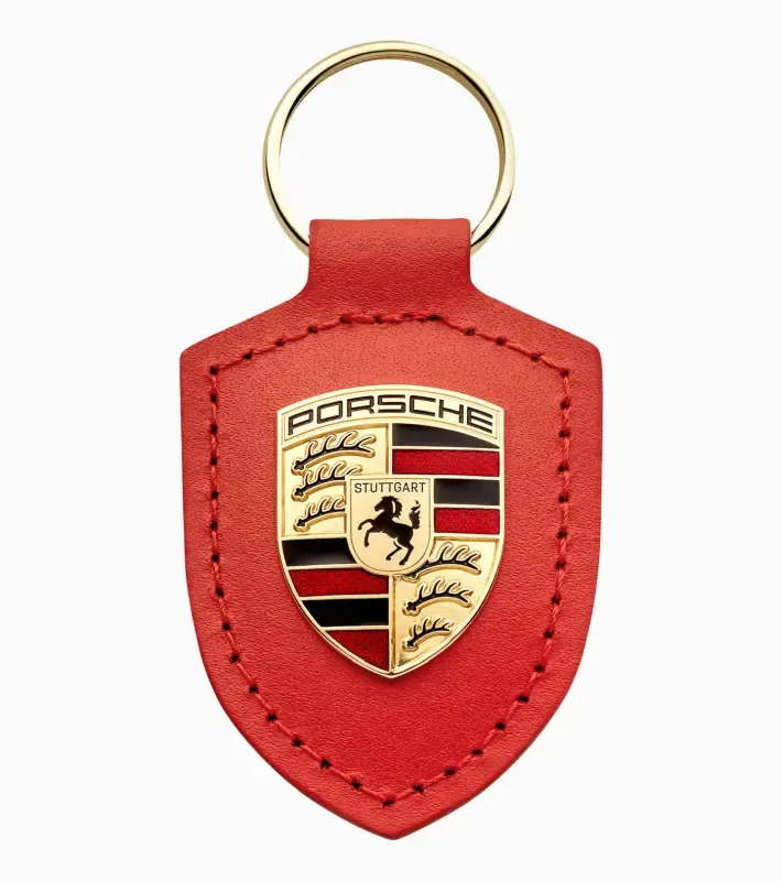 Porsche Crest Keyring 'Driven by Dreams' 75Y Přívěsek na klíče v edici 75Y lávově oranžová