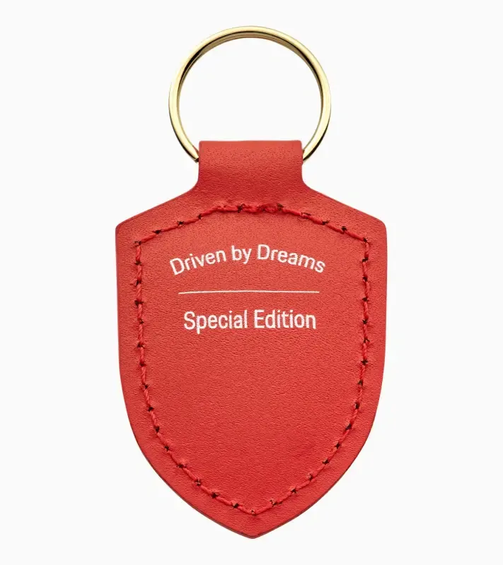 Porsche Crest Keyring 'Driven by Dreams' 75Y Přívěsek na klíče v edici 75Y lávově oranžová
