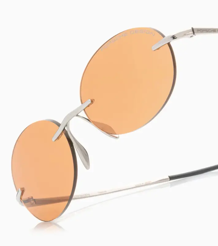 PORSCHE DESIGN P´86017 Sunglasses Liquid Titanium #7 Sluneční brýle bezrámečkové uni v barvě palladium se světle oranžovými skly