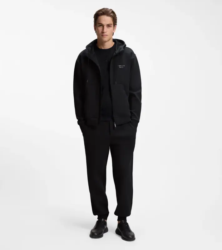 PORSCHE DESIGN Stretch-Jersey Tracksuit Bottoms with logo Porsche x BOSS Kalhoty volnočasové sportovní mírně strečové s náplety v černé