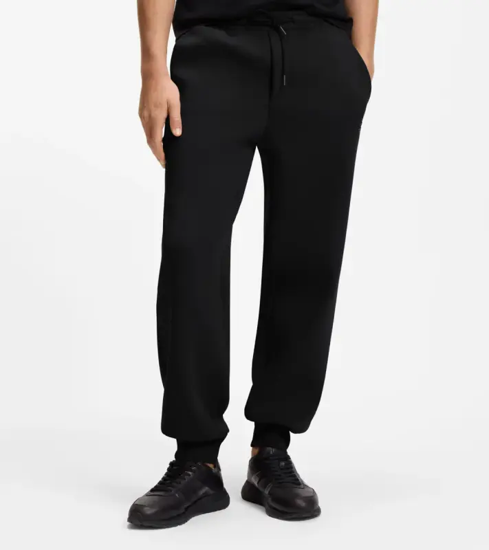PORSCHE DESIGN Stretch-Jersey Tracksuit Bottoms with logo Porsche x BOSS Kalhoty volnočasové sportovní mírně strečové s náplety v černé